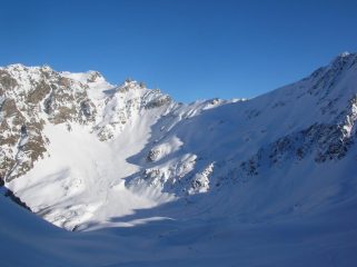Il canale che, dalla conca sottostante la sommità del Pisonet, scende sul pianoro dell' Alpe l' Ardamun fotografato dal Colle di Vameà.
