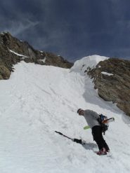 sci in spalla sotto il colle