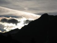 Uja di Ciamarella in controluce con nuvole