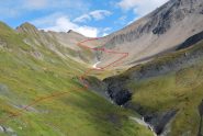 Il Col du Banderray visto dal sentiero del TMB con, in linea rossa, il percorso di salita. A sinistra del colle la Pointe de Combette.