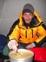 Luca prepara la polenta dentro la tenda
