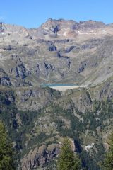 ...DAL SENTIERO CHE SCENDE ALLA FRAZIONE DI CHENEIL, SUL VERSANTE OPPOSTO DELLA VALLE, SI VEDONO LA DIGA DI CIGNANA. LA PICCOLA FRAZIONE DI FALEGNON E LA VASCA DI CARICO DI PROMORON...